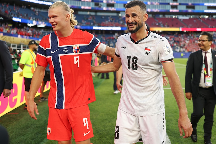 Erling Haaland and Aymen Hussein embrace after World Cup match.