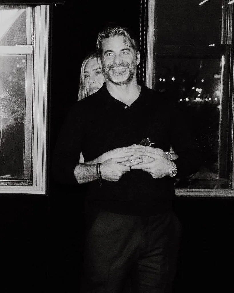 Jennifer Aniston and Jim Curtis embrace in a snap taken at the latter's 50th birthday party, shared on Instagram