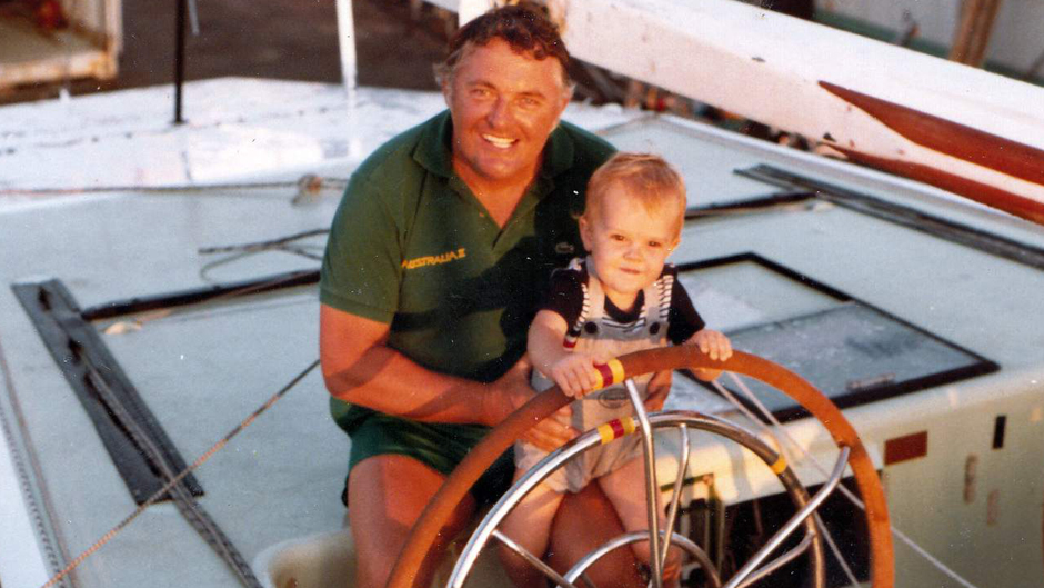 Alan Bond sits at the wheel of Australia II