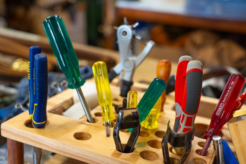 brown leather inside a pine store adorned with whips, tools and work stations
