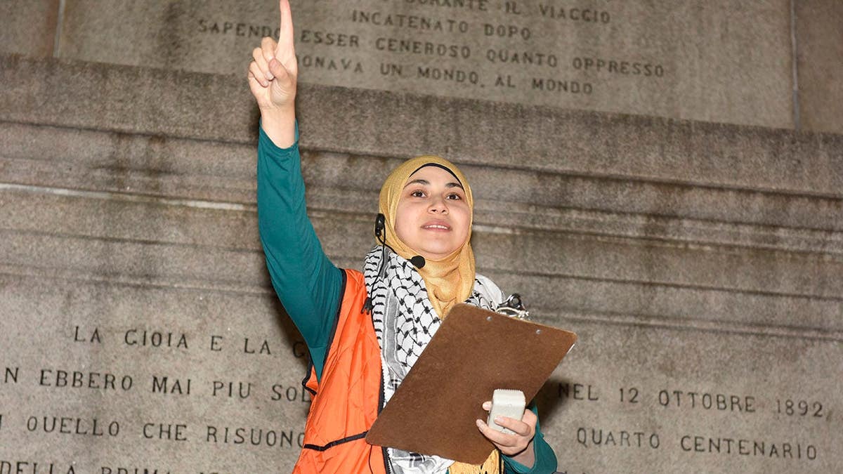 Aber Kawas speaking at a rally in Columbus Circle