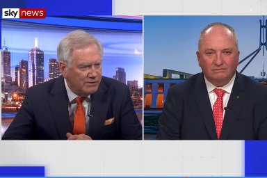 Split screen of Andrew Bolt and Barnaby Joyce both wearing blue suits.