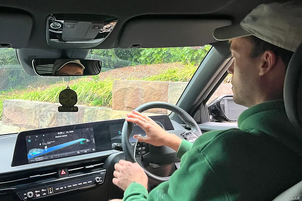 Aden behind the wheel of his Kia EV6.