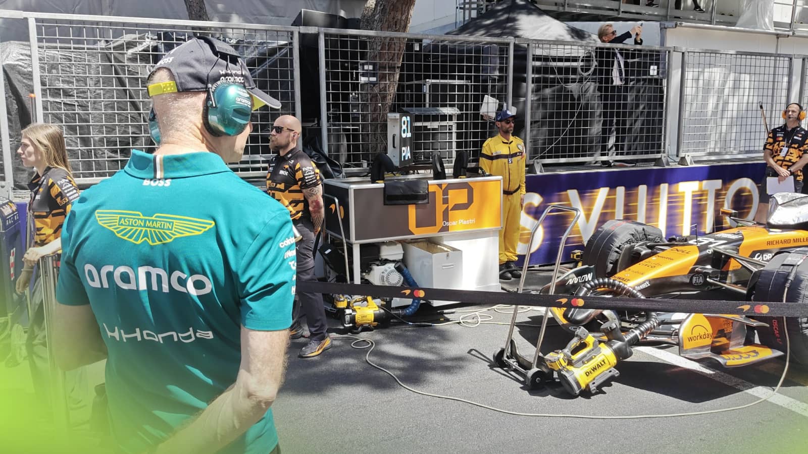 Adrian Newey stood on the grid in Monaco while stood in front of the MCL40 of Oscar Piastri with the nose of the car visible