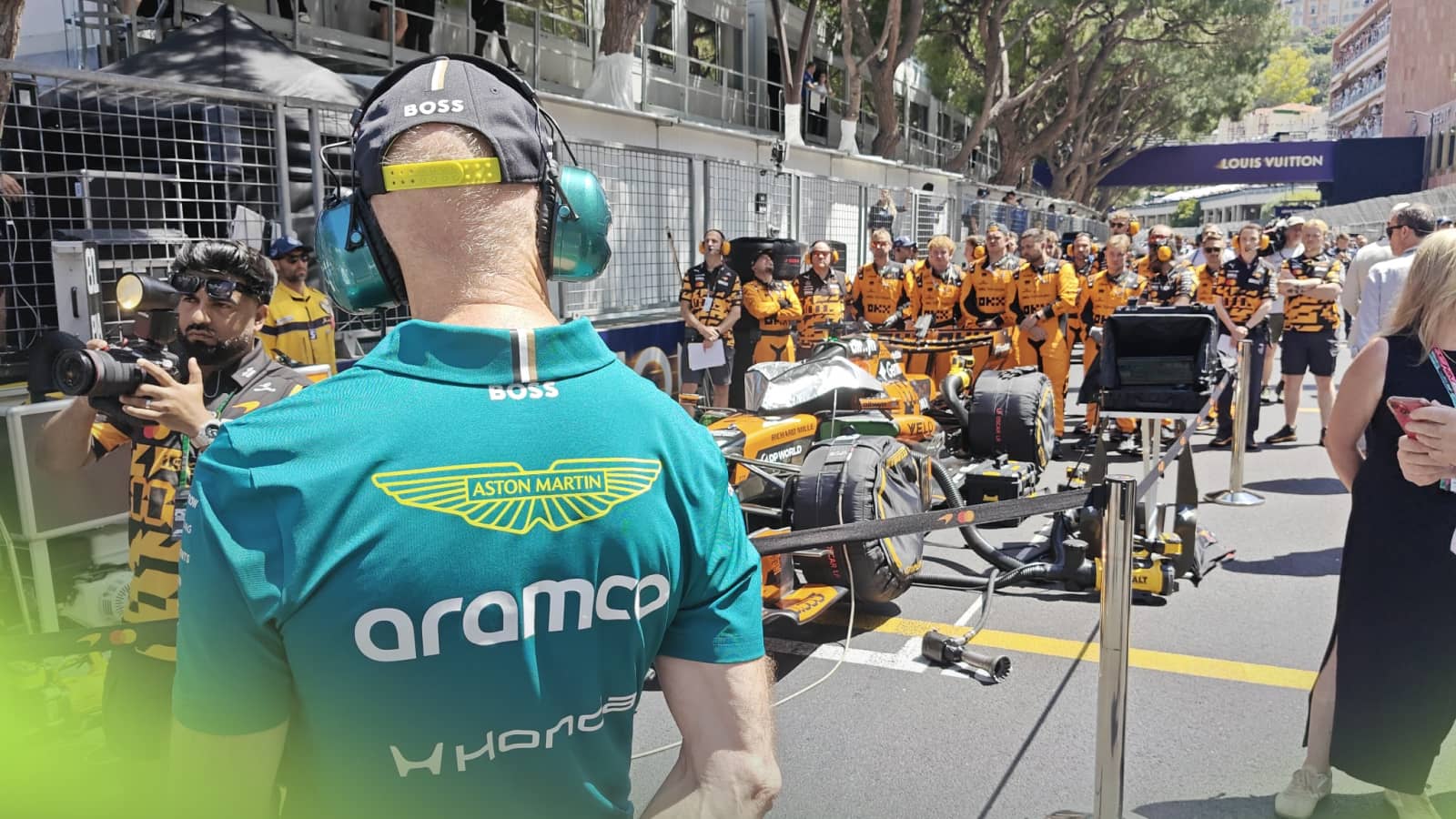 A behind shot of Adrian Newey examining Oscar Piastri's McLaren on the grid in Monaco