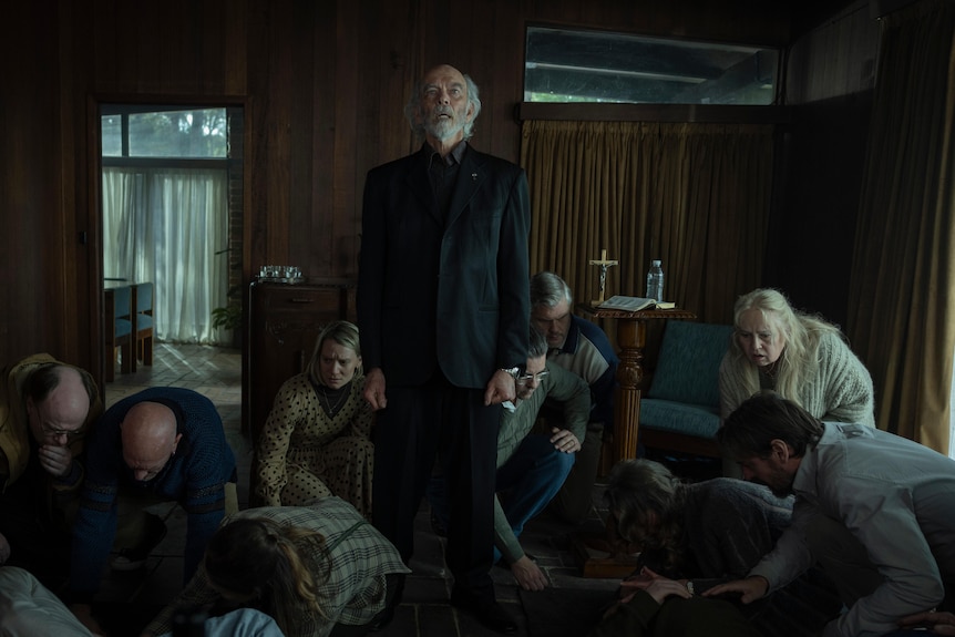 A group gather around a pastor