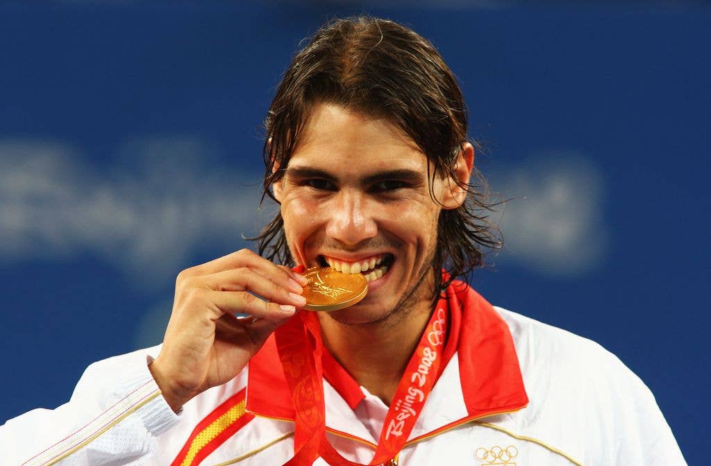 Rafael Nadal bites his gold medal at the 2008 Beijing Olympic Games.