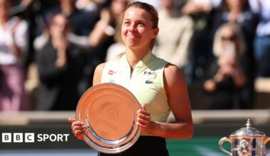 Maja Chwalinska smiles while holding the French Open women's singles runner-up trophy