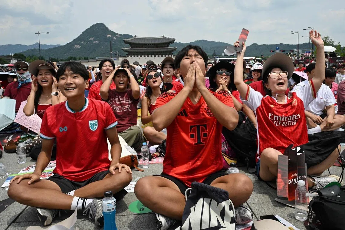 South Korean fans react as they watch their team play Mexico in the World Cup at Gwanghwamun Square in Seoul on June 19.