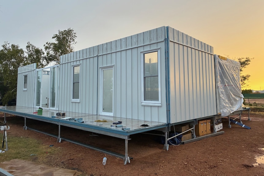 white house without a roof sits on block of land in the outback