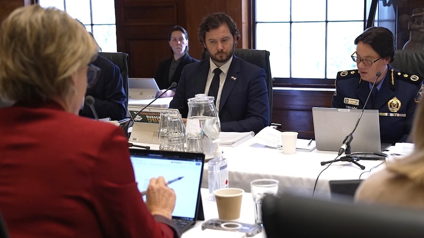 People sit at a table in a meeting.
