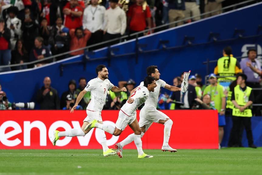 Players from IR Iran react after scoring a disallowed goal
