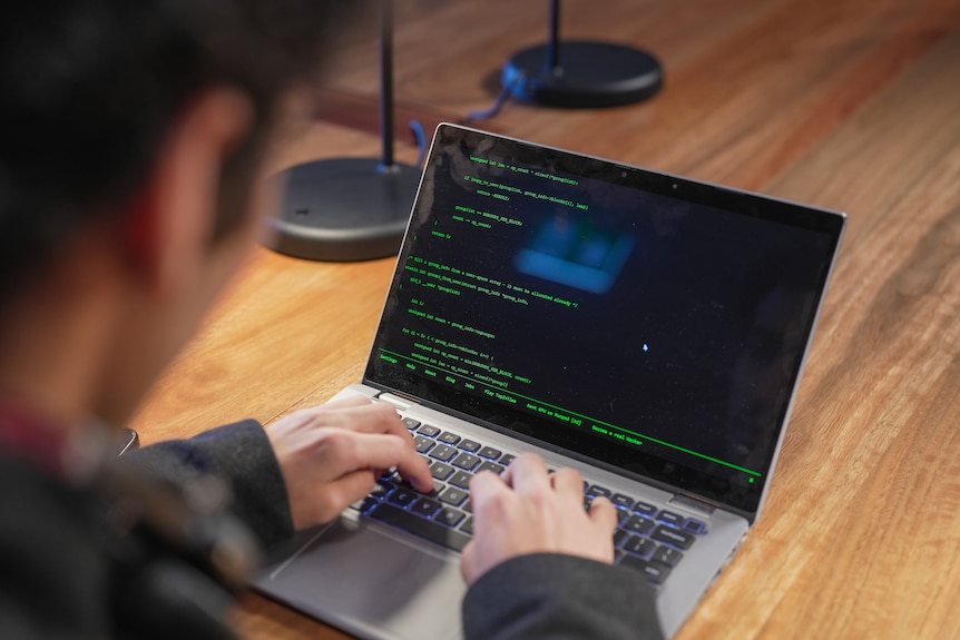 A man types on a computer.