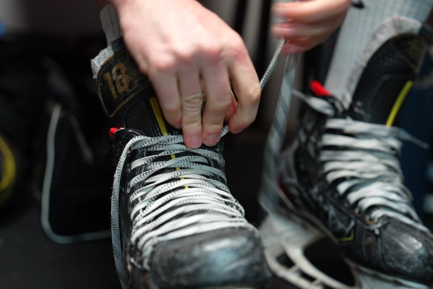 Ice hockey boots being tied up