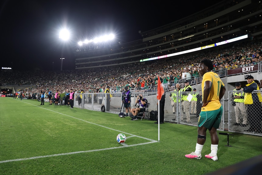 Nestory Irankunda of the Socceroos lines up a corner kick.