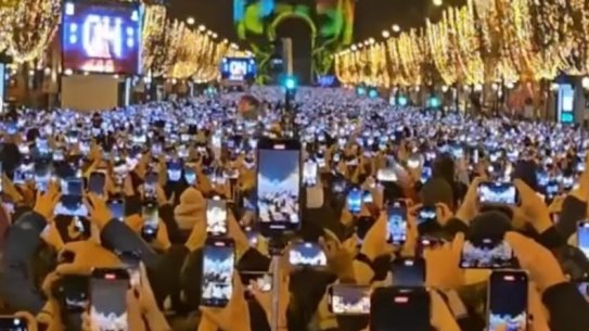 Revellers at the Arc de Triomphe in Paris on New Year’s Eve are too busy filming to celebrate the arrival of the new year.