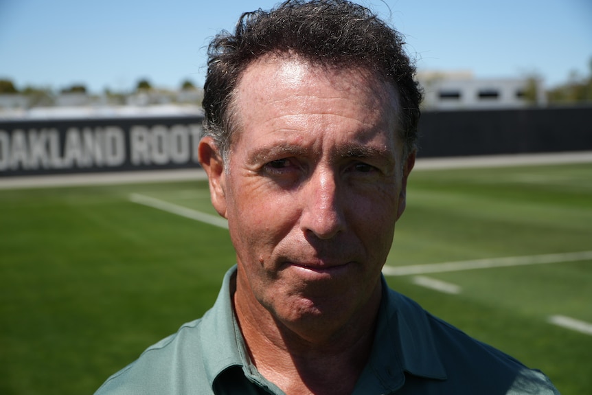 A close up profile of a man on soccer field