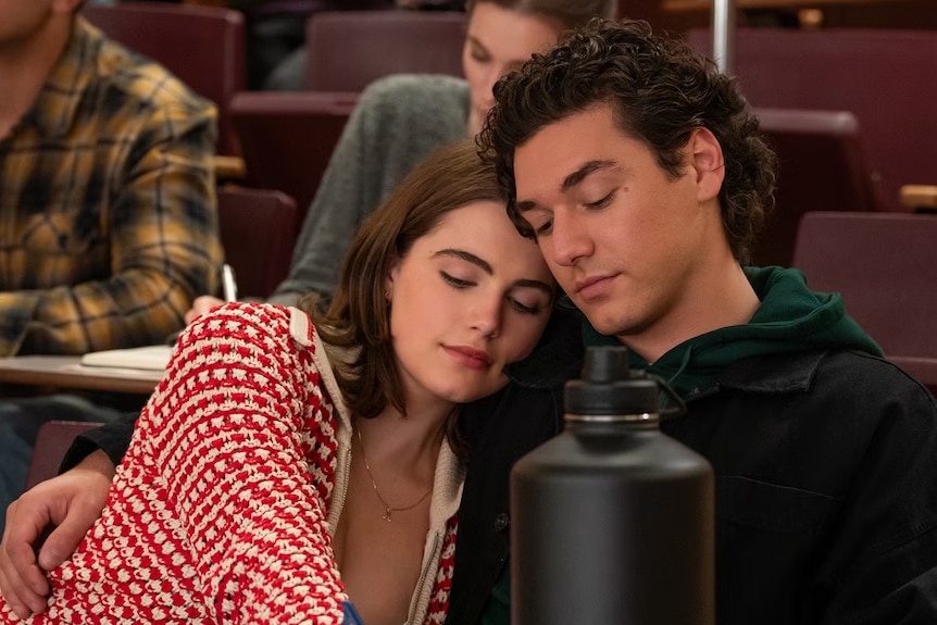 Ella Bright and Belmont Cameli intimately close in a lecture theatre in a scene from Off Campus.