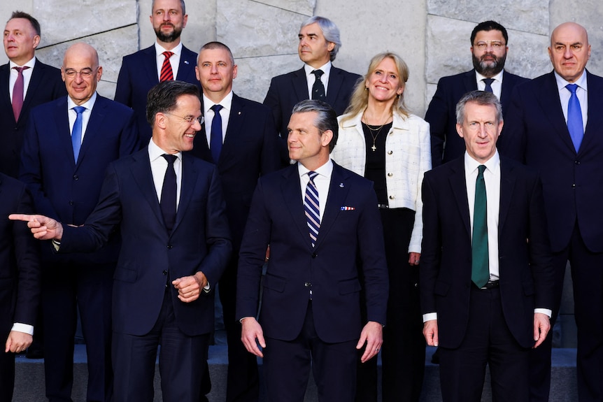 Mark Rutte gestures next to Pete Hegseth and other world defence ministers