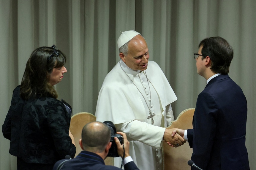 The pope shakes hand with Christopher Olah.