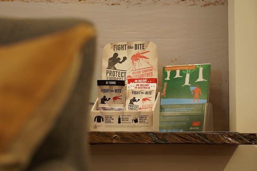 A collection of pamphlets sitting on a wooden table. They are titled: "Fight the Bite".
