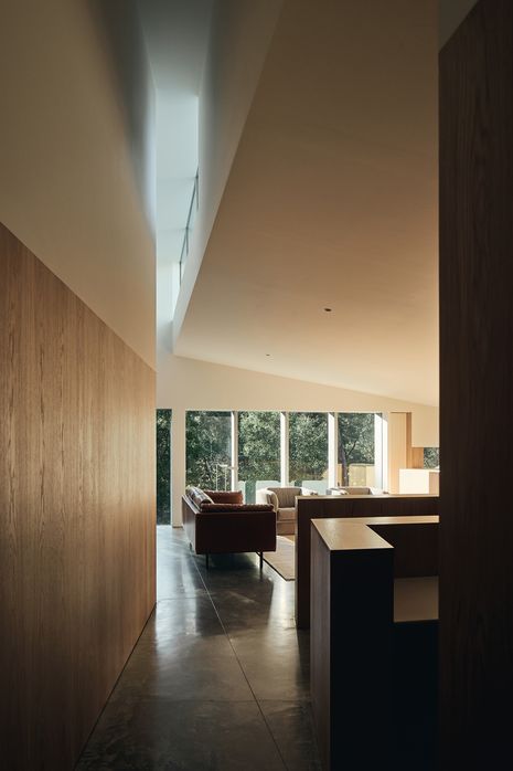A kink in the hallway wall accentuates the height of the central chimney-like volume.