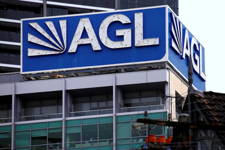 A corporate building with a large "AGL" sign on the roof.