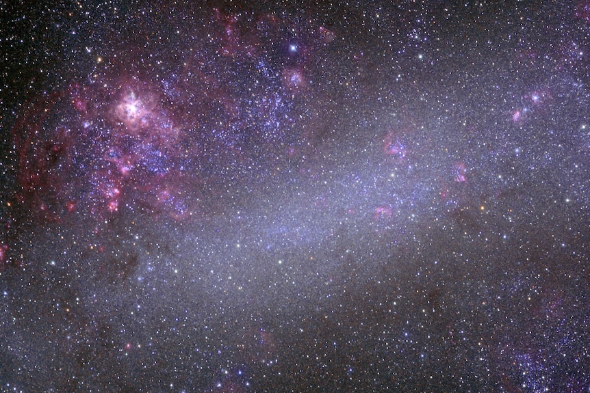 A purple, pink and black view of a starry, space night with flashes of bright light.