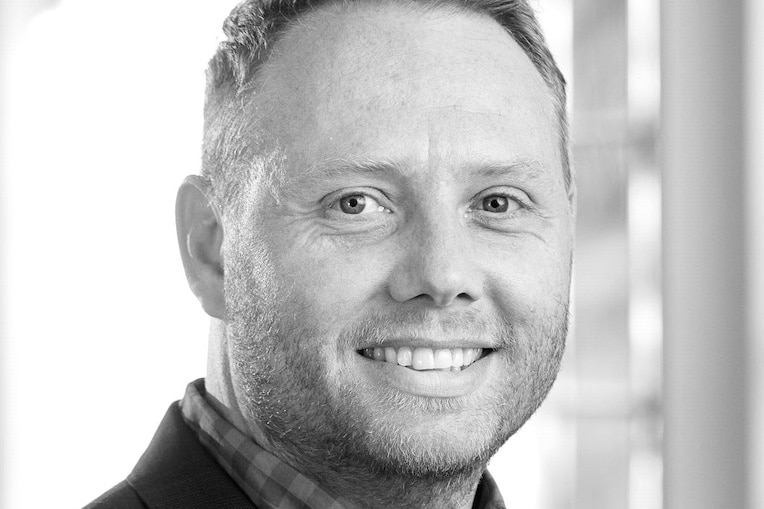 An adult caucasian male smiling.