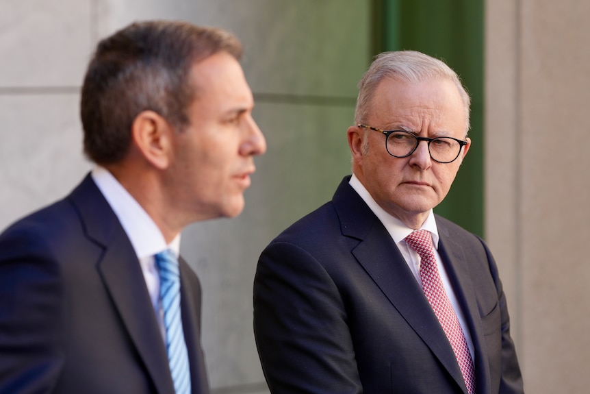 two men in suits at a press conference - Prime Minister Albanese and Treasurer Chalmers
