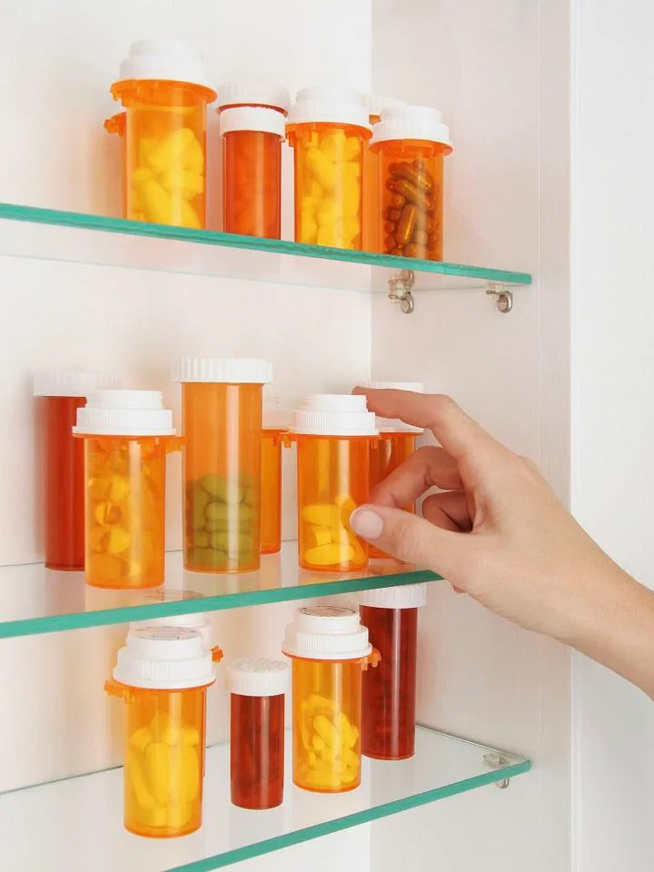 Stock image of a woman reaching into her medicine cabinetCredit: Getty