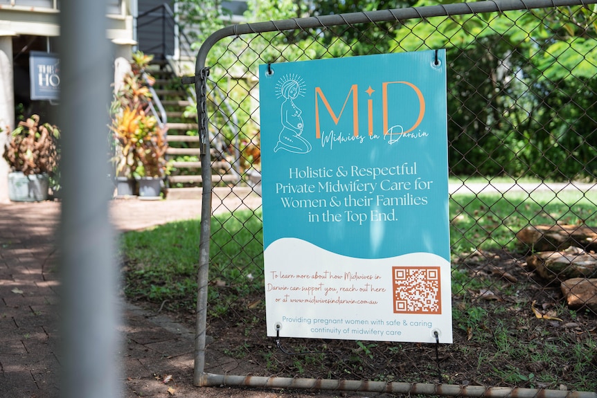 A sign on a fence.