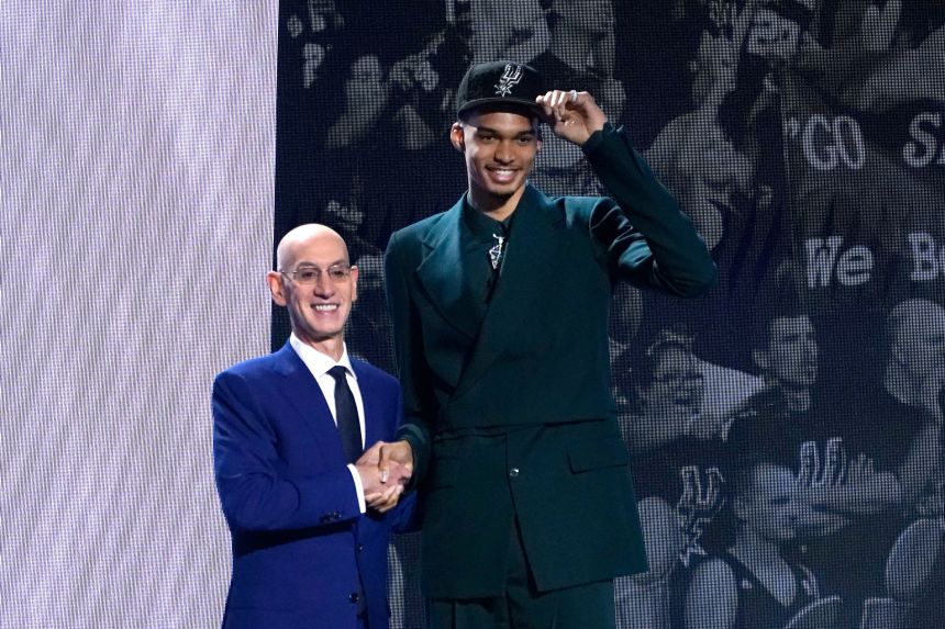 Victor Wembanyama, right, shakes hands with NBA commissioner Adam Silver at the 2023 NBA draft.