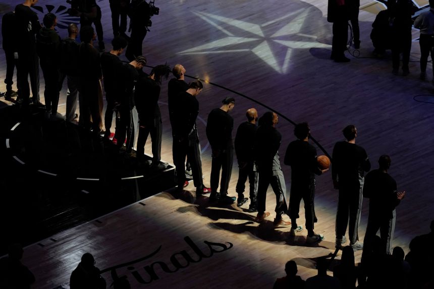The San Antonio Spurs stand for the National Anthem before the game against the New York Knicks on Wednesday.