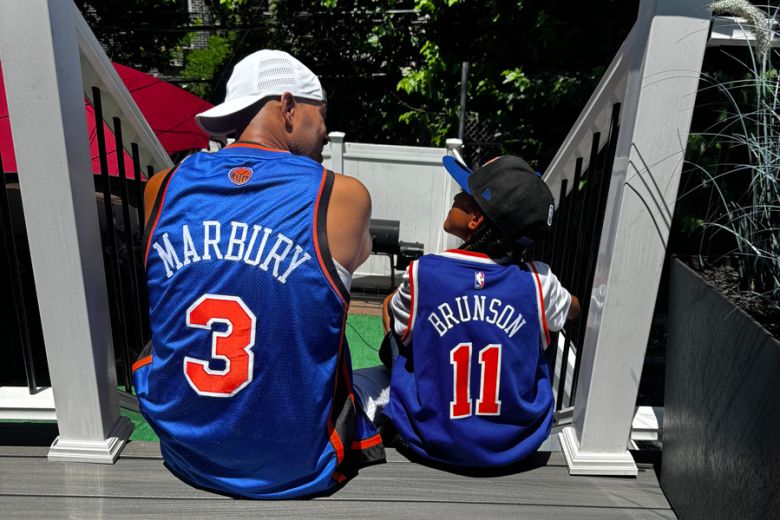 Photo of Bryce Booker (9) and his dad Quron Booker, a lifelong New Yorker and Knicks fan. The pair are extremely close and bond over their love for basketball and hope for a championship win.