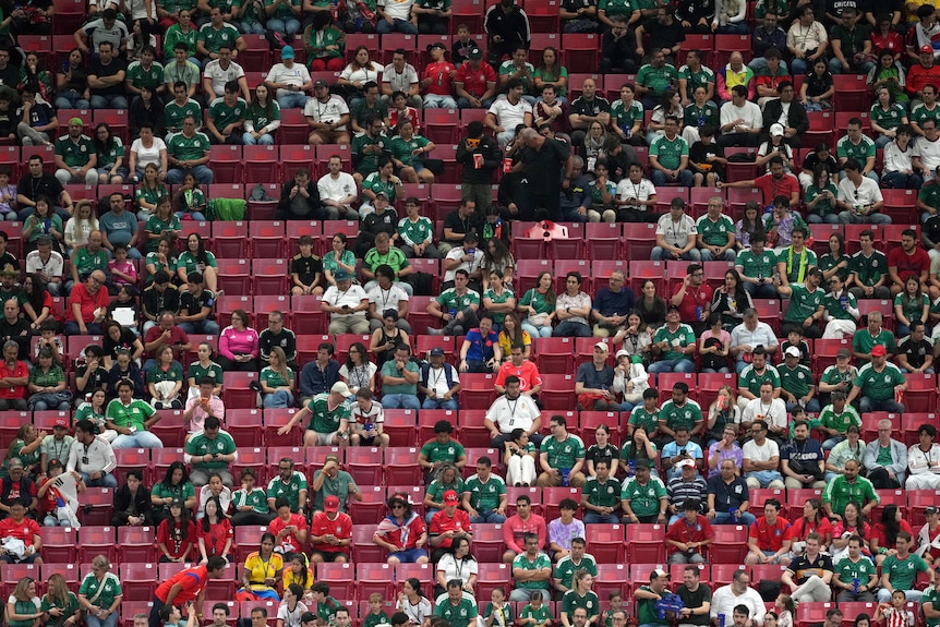 Empty seats are scattered throughout the crowd in a stadium