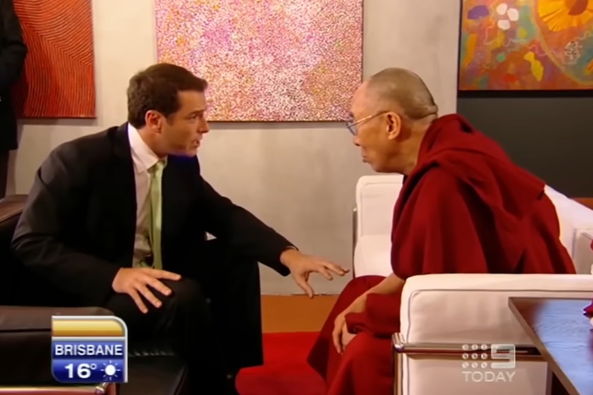 Karl Stefanovic leaning over speaking to the Dalai Lama