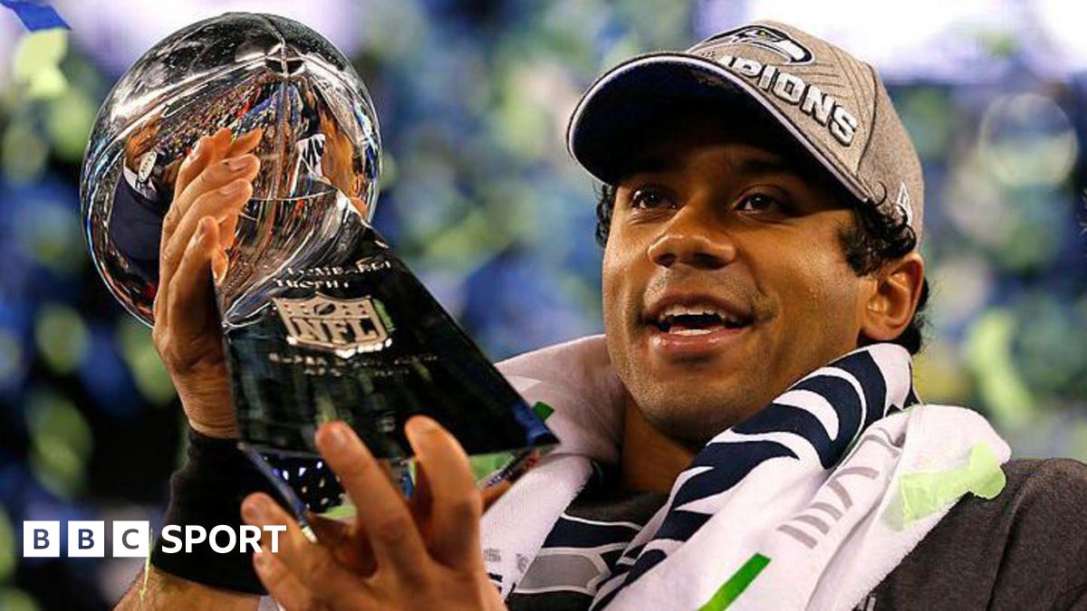 Russell Wilson holding the Lombardi Trophy after the Seattle Seahawks win the Super Bowl in 2014