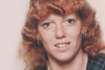 A smiling young woman with ginger hair.