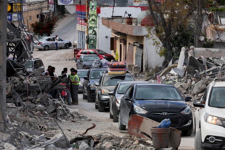 Cars line up in war ravaged town in southern Lebanon as displaces people head home