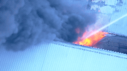 7NEWS helicopter footage shows flames continue to engulf the facility.