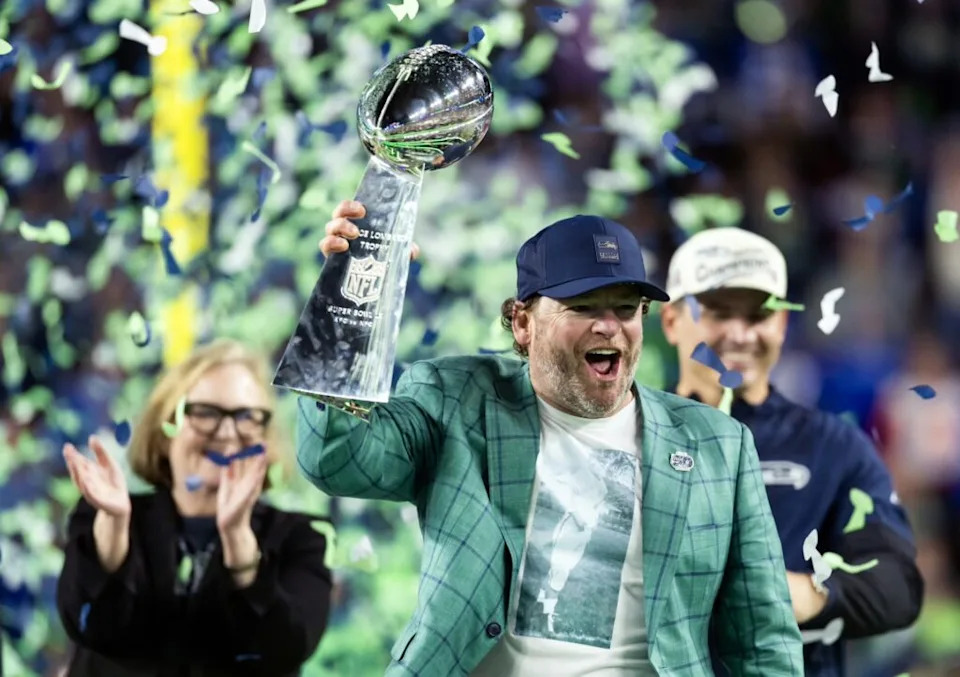 Seattle Seahawks general manager John Schneider celebrates with the Vince Lombardi trophy on the podium after defeating the New England Patriots in Super Bowl LX at Levi's Stadium.
