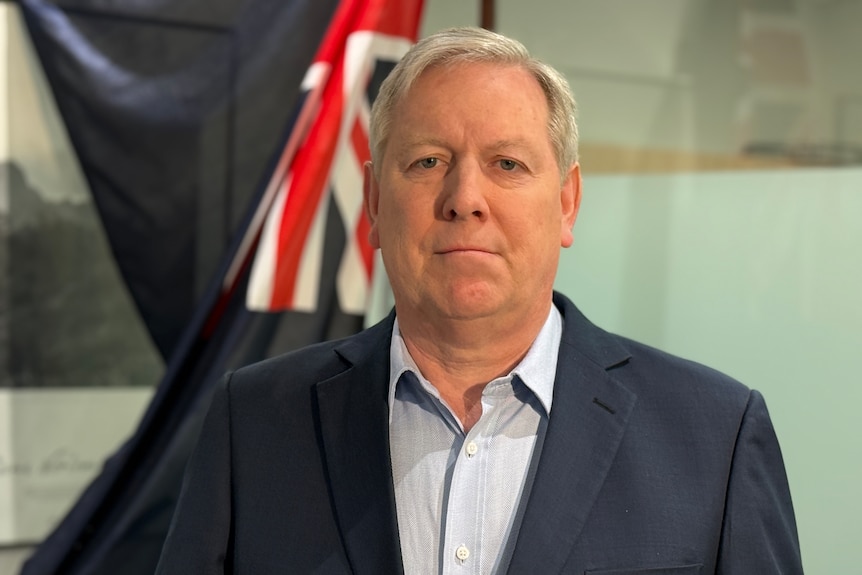 A grey-haired politician in his office.