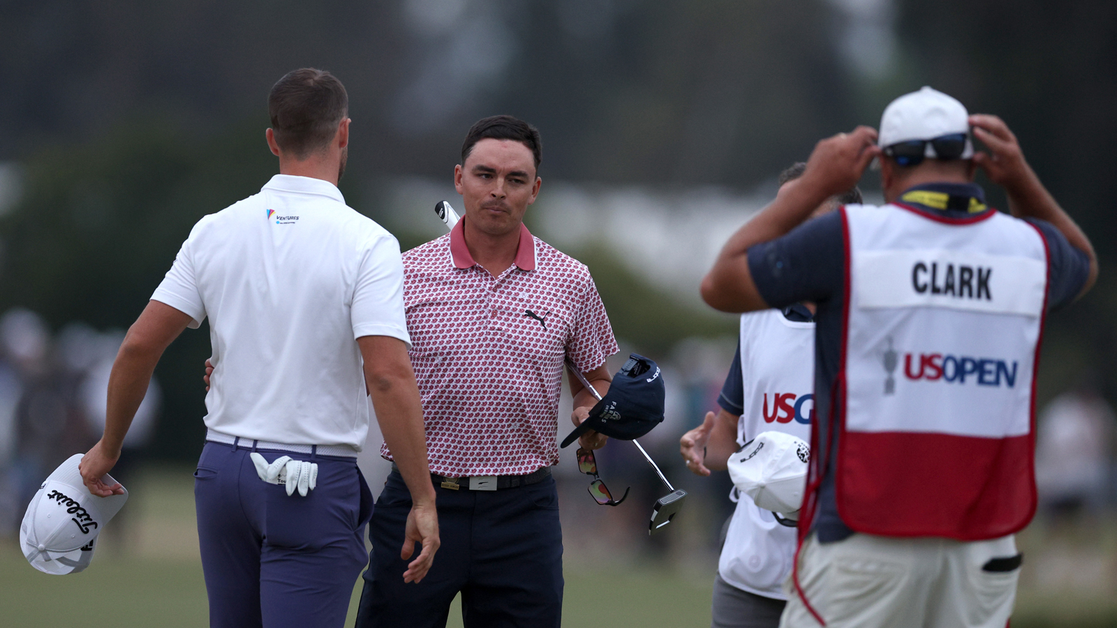 Wyndham Clark and Rickie Fowler shake hands on the 18th green