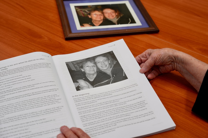 Hands holding a book titled "The other side of overdose".