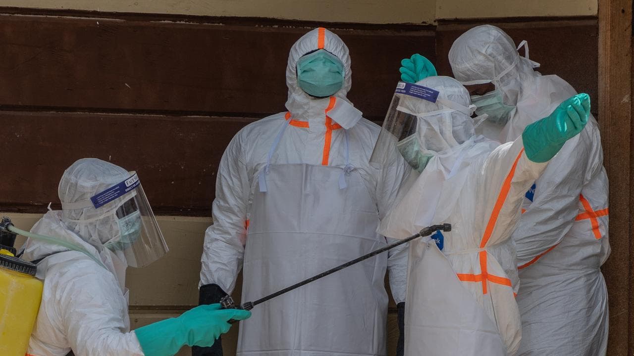 Health workers disinfect themselves