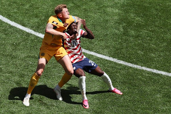 Harry Souttar and Folarin Balogun clash during the game.