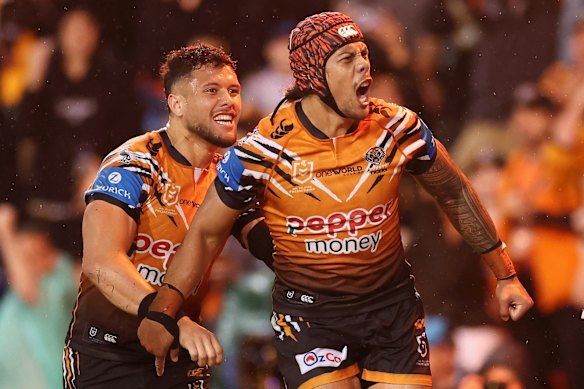 Jarome Luai yells in the direction of Wests Tigers fans after scoring against the Titans.