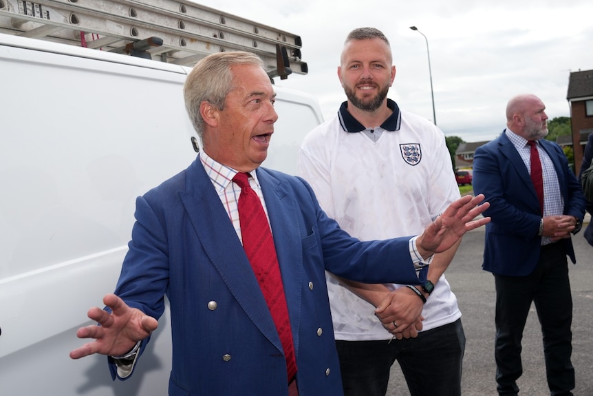 Two men talking and walking.
