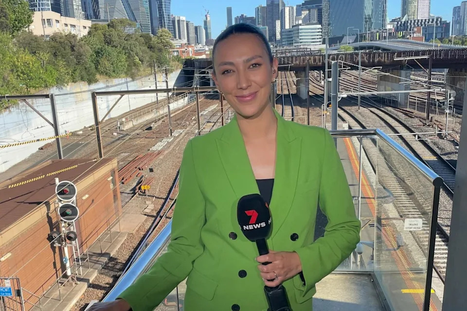Estelle Griepink standing next to a train station